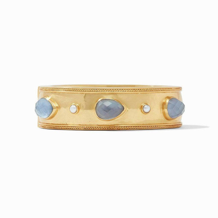 Gold hinge bangle featuring blue and white gemstones.