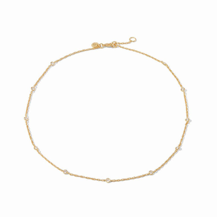 Gold chain necklace with small, clear stones; delicate design.