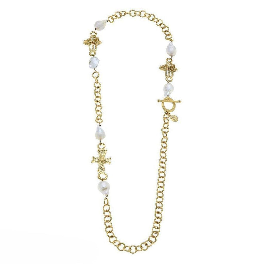 Gold chain necklace with baroque pearls and ornate cross charms.