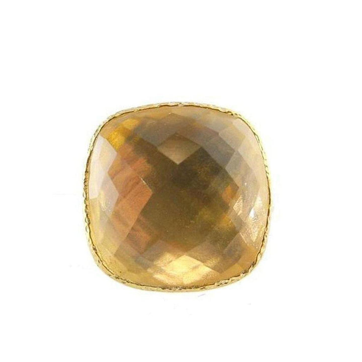 Golden cushion-cut citrine ring with gold bezel setting.