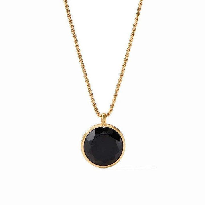 Gold chain necklace with a large, faceted black stone pendant.
