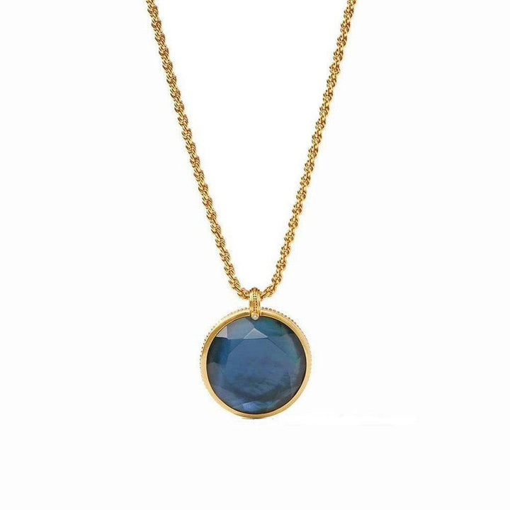 Gold rope chain necklace with a dark blue reversible statement pendant.