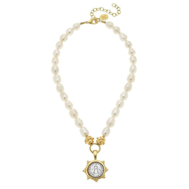 Elegant pearl necklace with gold accents and a bee coin pendant.