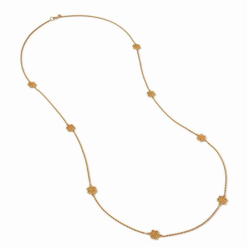 Gold long necklace featuring textured floral accents.