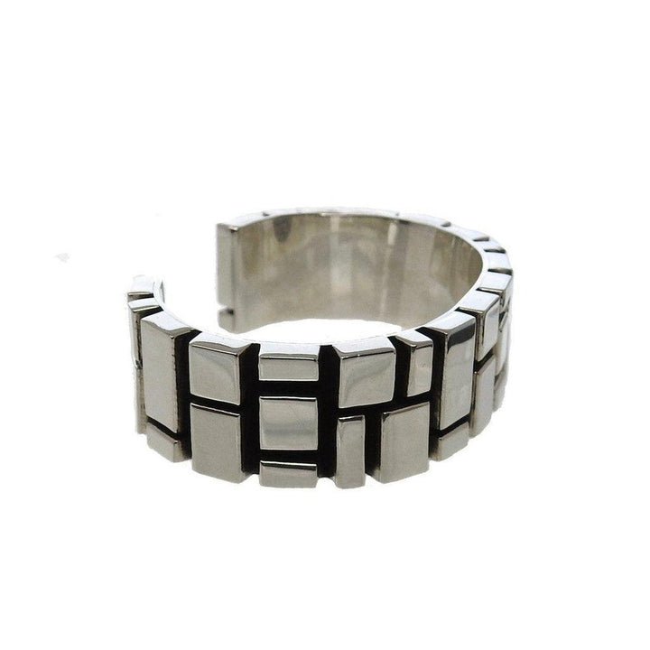 Sterling silver cuff bracelet with geometric design.