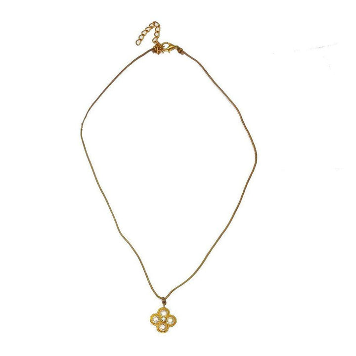 Gold flower pendant necklace on brown cord.