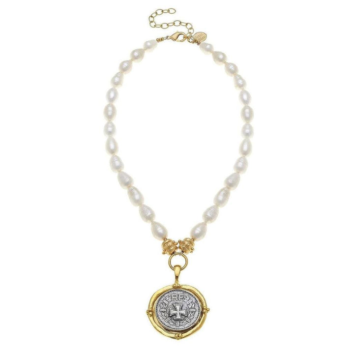Elegant pearl necklace with spinning coin pendant featuring a cross detail.