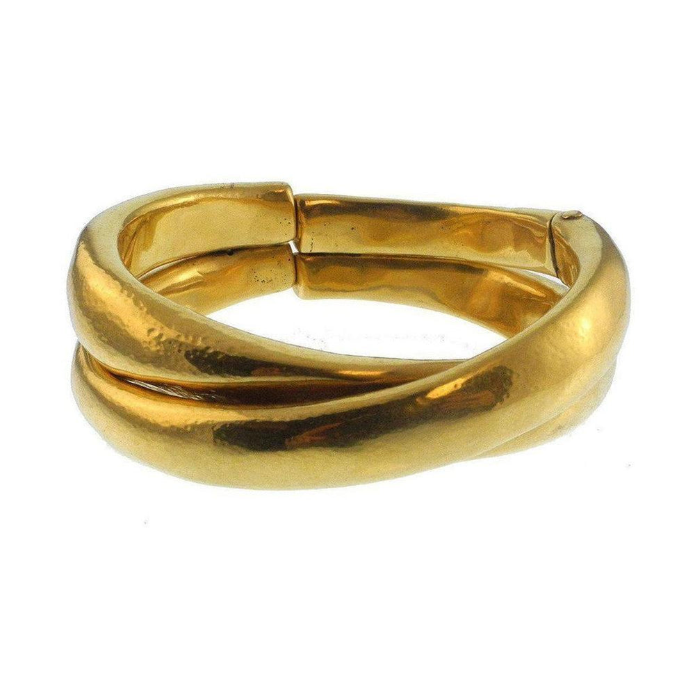 Gold cuff bracelet with intertwined bands, smooth finish.