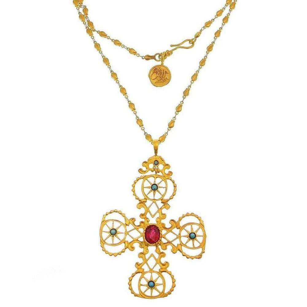 Gold cross necklace with red and blue gemstones, ornate design