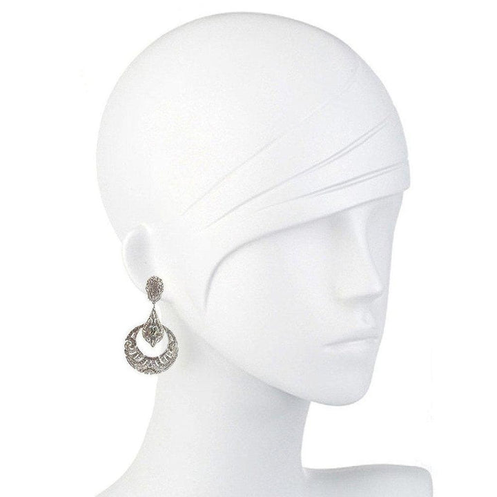 Elegant silver deco clip earrings displayed on a mannequin.