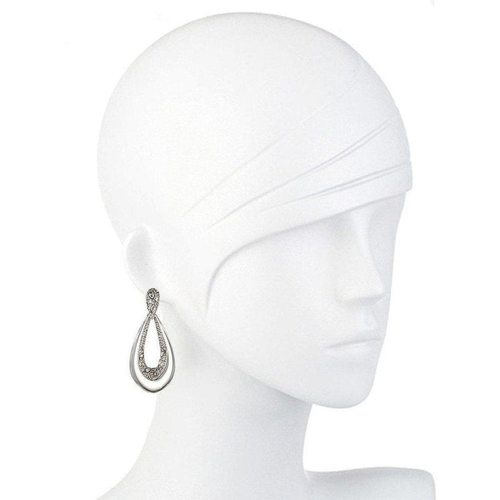 Teardrop-shaped crystal earrings on a mannequin, showcasing sparkling detail.