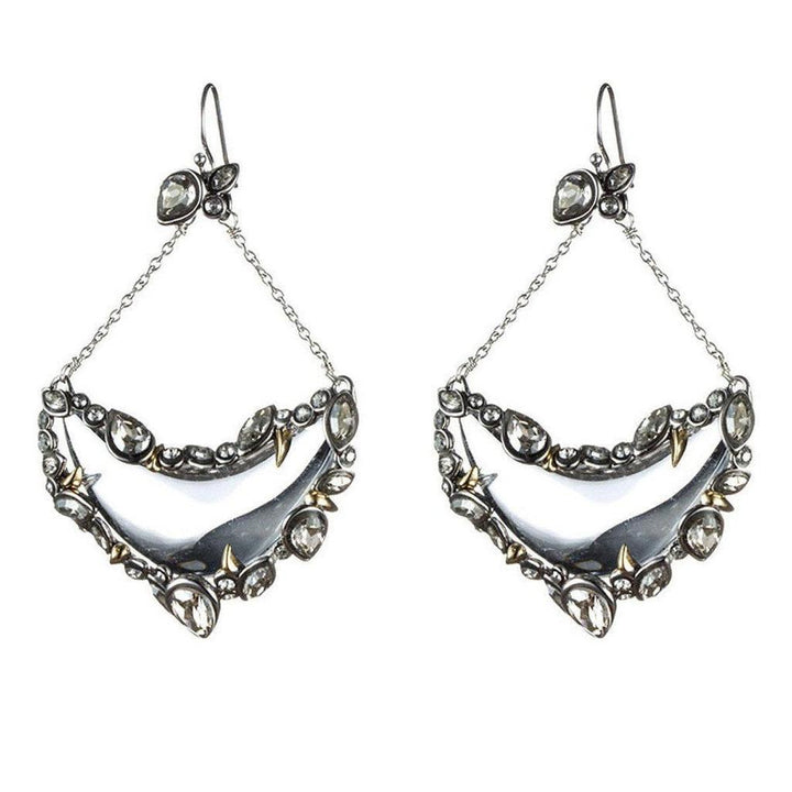 Silver crescent earrings with crystals and gold accents; statement jewelry.