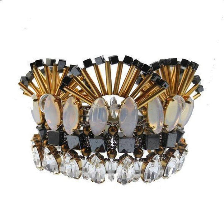 Multi-layered bracelet featuring opal, hematite, and crystal accents; gold and black tones.