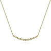 Curved diamond bar necklace in 14k yellow gold with bezel-set diamonds.