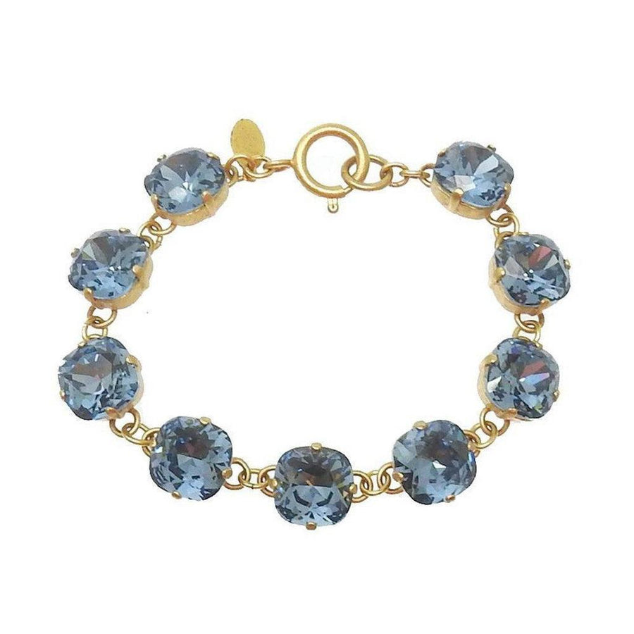 Montana Cushion Cut Tennis Bracelet: Gold chain, light blue crystals.