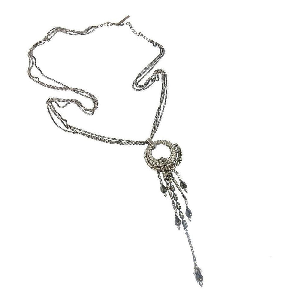 Elegant silver necklace with crystal and dark stone accents, featuring a layered chain and dangling pendant.