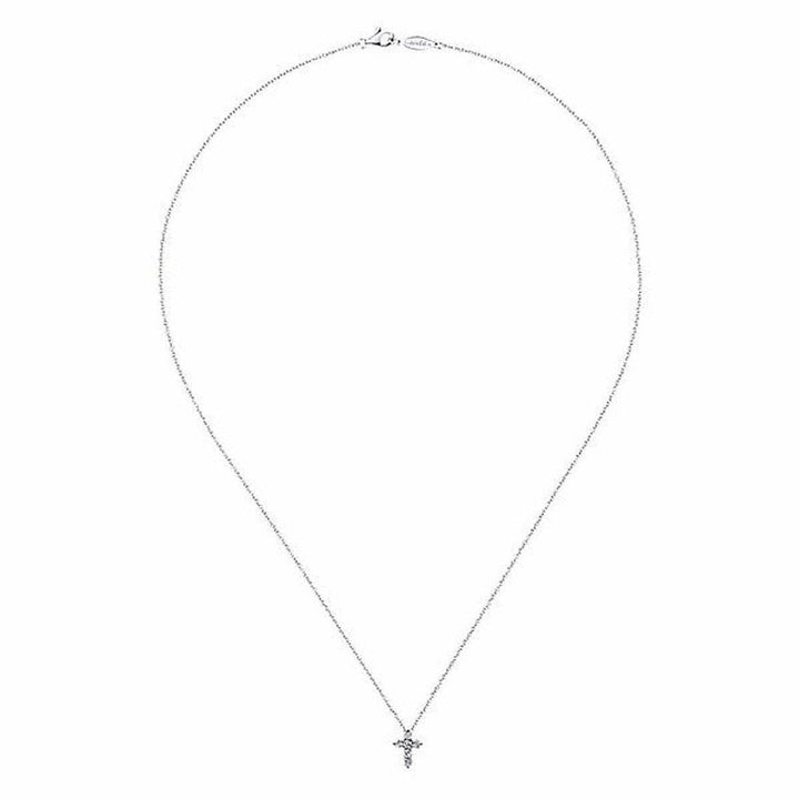 Delicate diamond cross pendant on a thin silver chain.