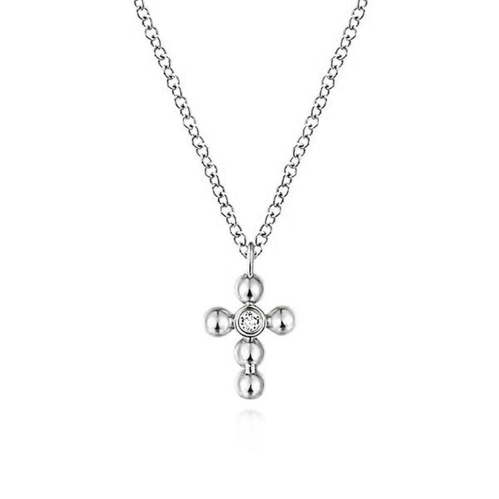 White gold diamond cross necklace with beaded detail.