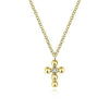 Delicate yellow gold cross necklace with a single diamond accent.