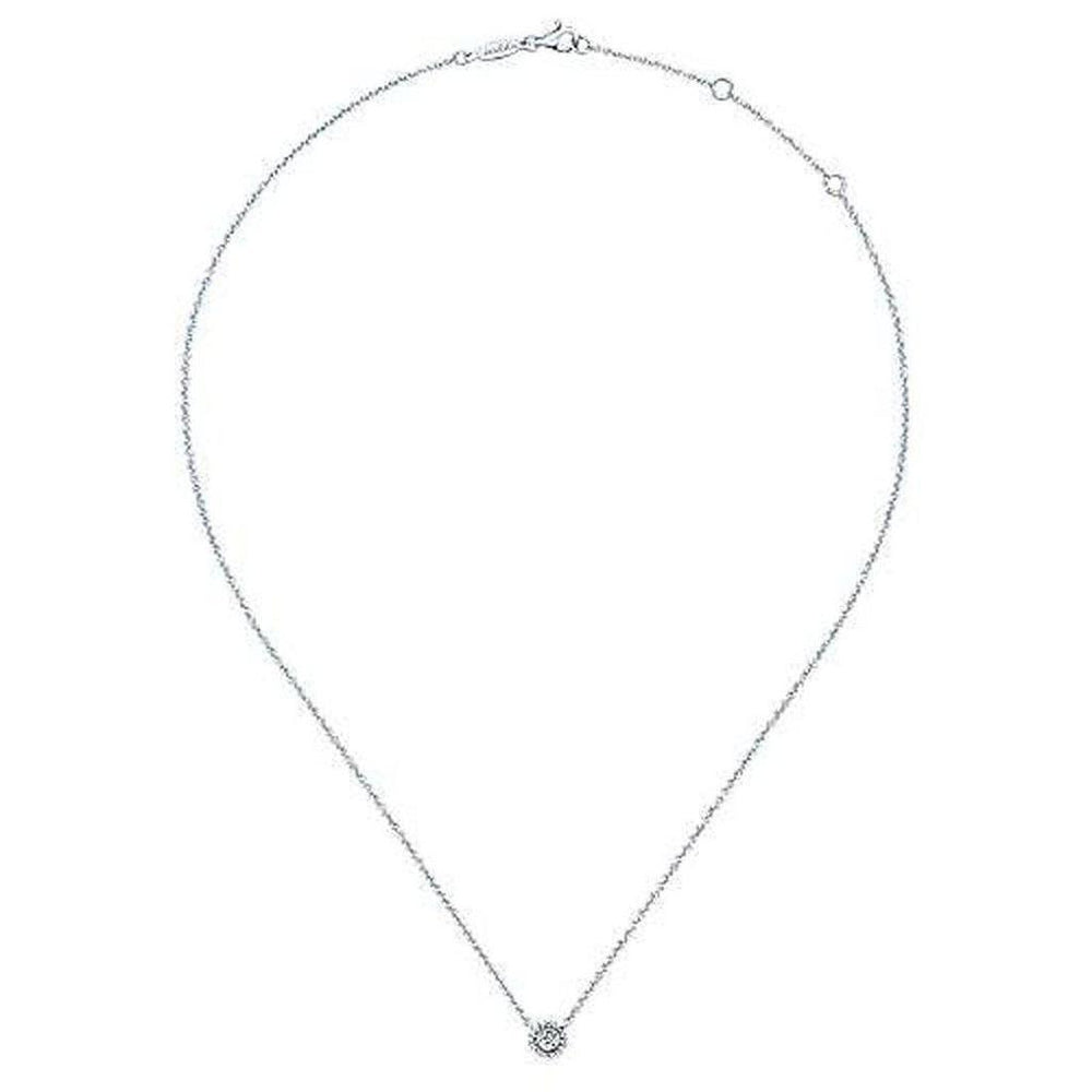 Dainty diamond pendant necklace on a delicate chain.