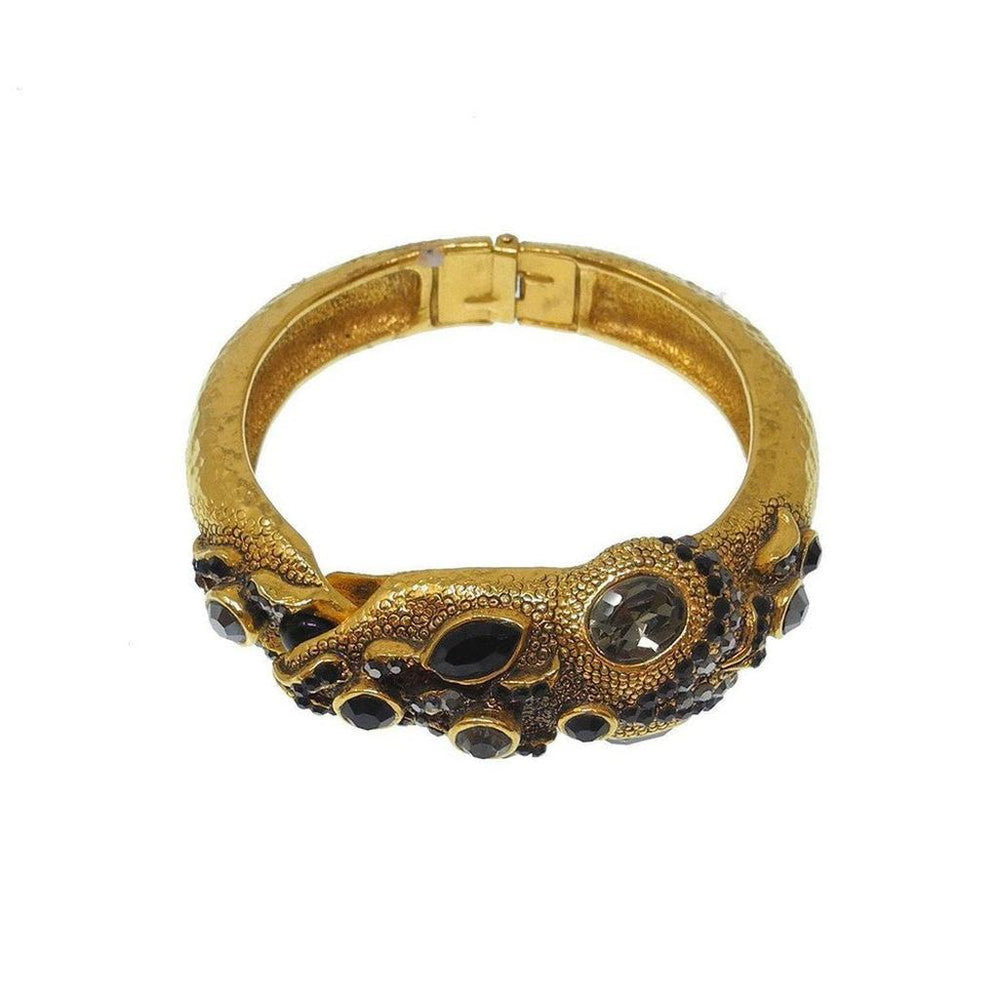 Gold hinged bracelet adorned with black and smoky quartz crystals.