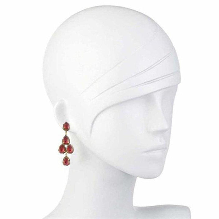 Red gemstone drop earrings on a mannequin, showcasing a tiered design.