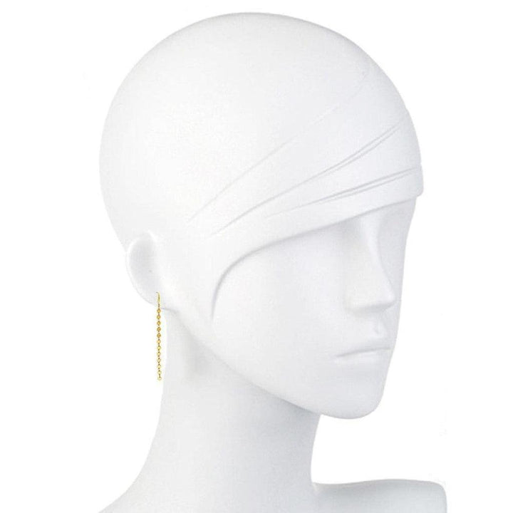 Gold chain earrings on a mannequin, showcasing their length and delicate design.