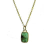 Emerald necklace with 18k gold chain and rectangular gemstone pendant.