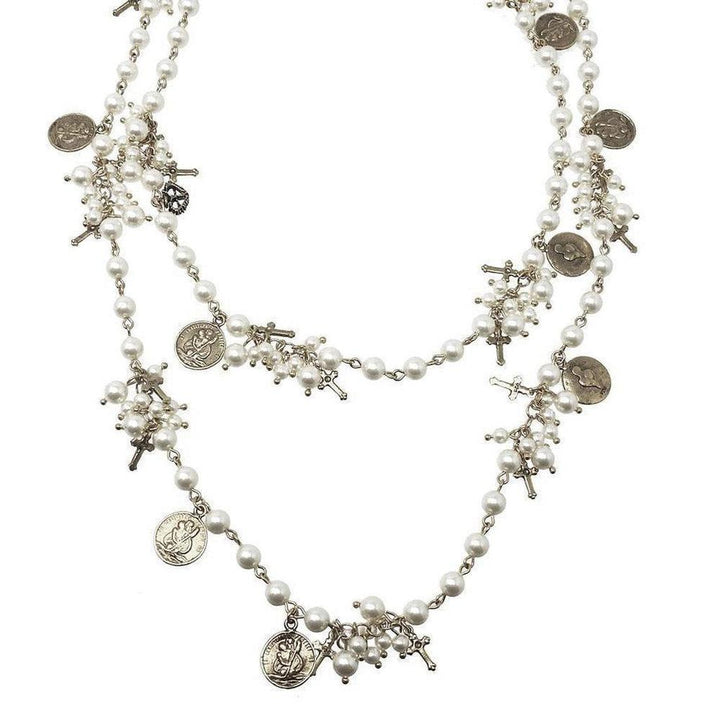 Double-strand pearl necklace adorned with antique-style charms and crosses.