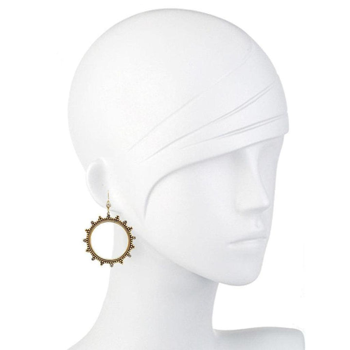 Gold hoop earrings with textured detailing and small stones, shown on a mannequin.