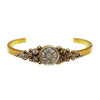 Fay Winged Cuff: Gold cuff bracelet featuring a central antique coin with a starburst design, accented with sparkling crystals.