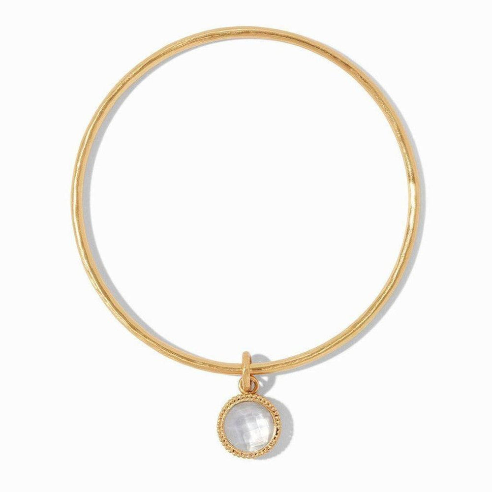 Gold bangle bracelet with a delicate, faceted opal charm.
