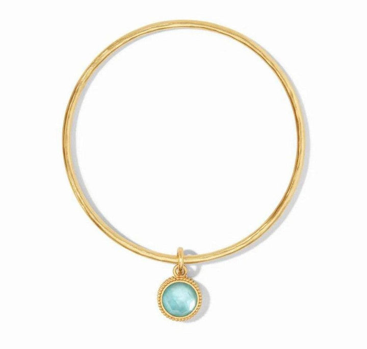 Gold Fleur-de-Lis bangle with light blue gemstone charm