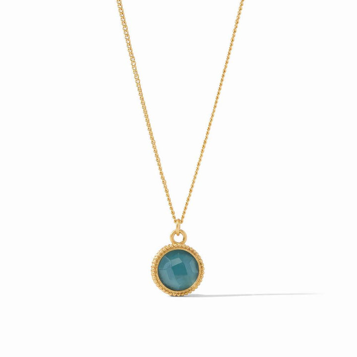 Gold chain necklace with teal gemstone pendant.