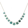 Teal gemstone necklace on brown cord, featuring teardrop-shaped stones.