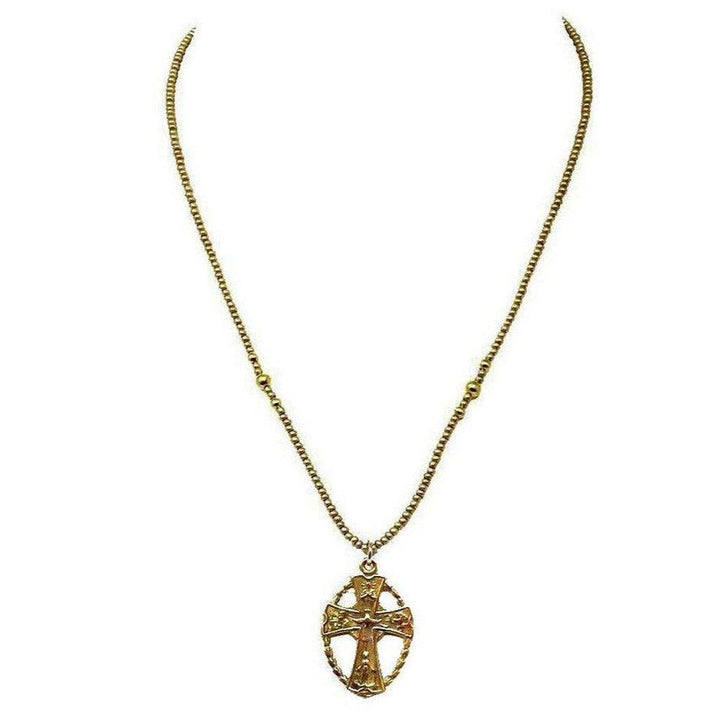 Gold necklace featuring an ornate cross pendant on a beaded chain.
