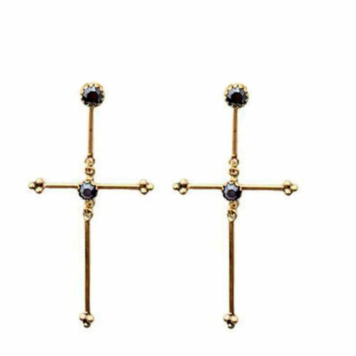Gold cross earrings with dark gemstone accents.