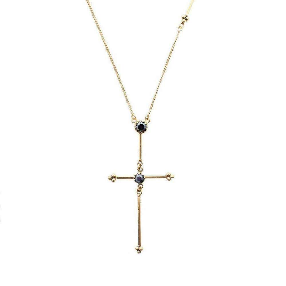 Gold chain necklace featuring a long, ornate cross pendant accented with dark stones.