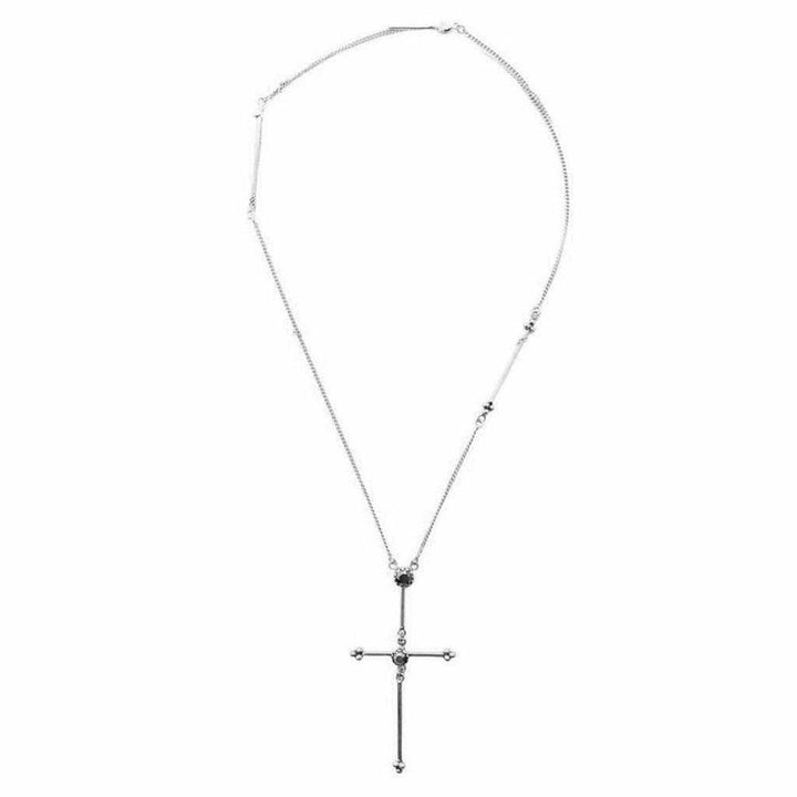 Silver cross necklace with dark stones, delicate chain.