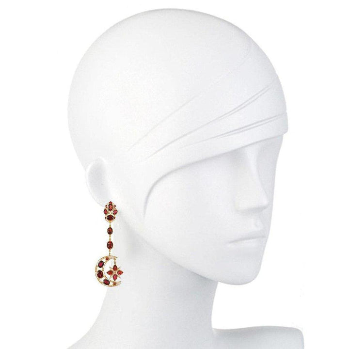 Red garnet and gold moon and star drop earrings on a mannequin.