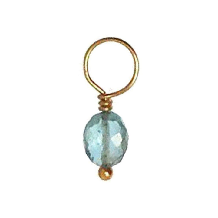 Aqua gemstone pendant with gold wire accents.