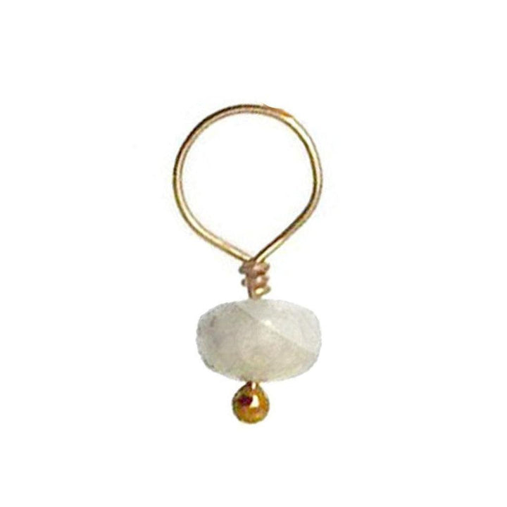 White gemstone accent with gold wire and bead