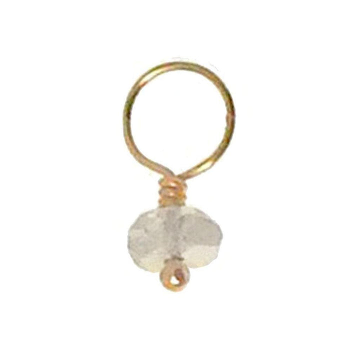Gold wire accent with a small, faceted gemstone pendant.