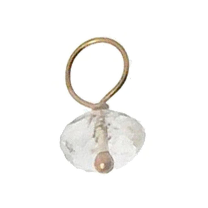 Clear quartz gemstone accent with gold wire loop, delicate jewelry detail.