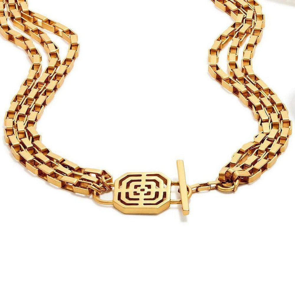 Gold triple-strand necklace with geometric patterned clasp.