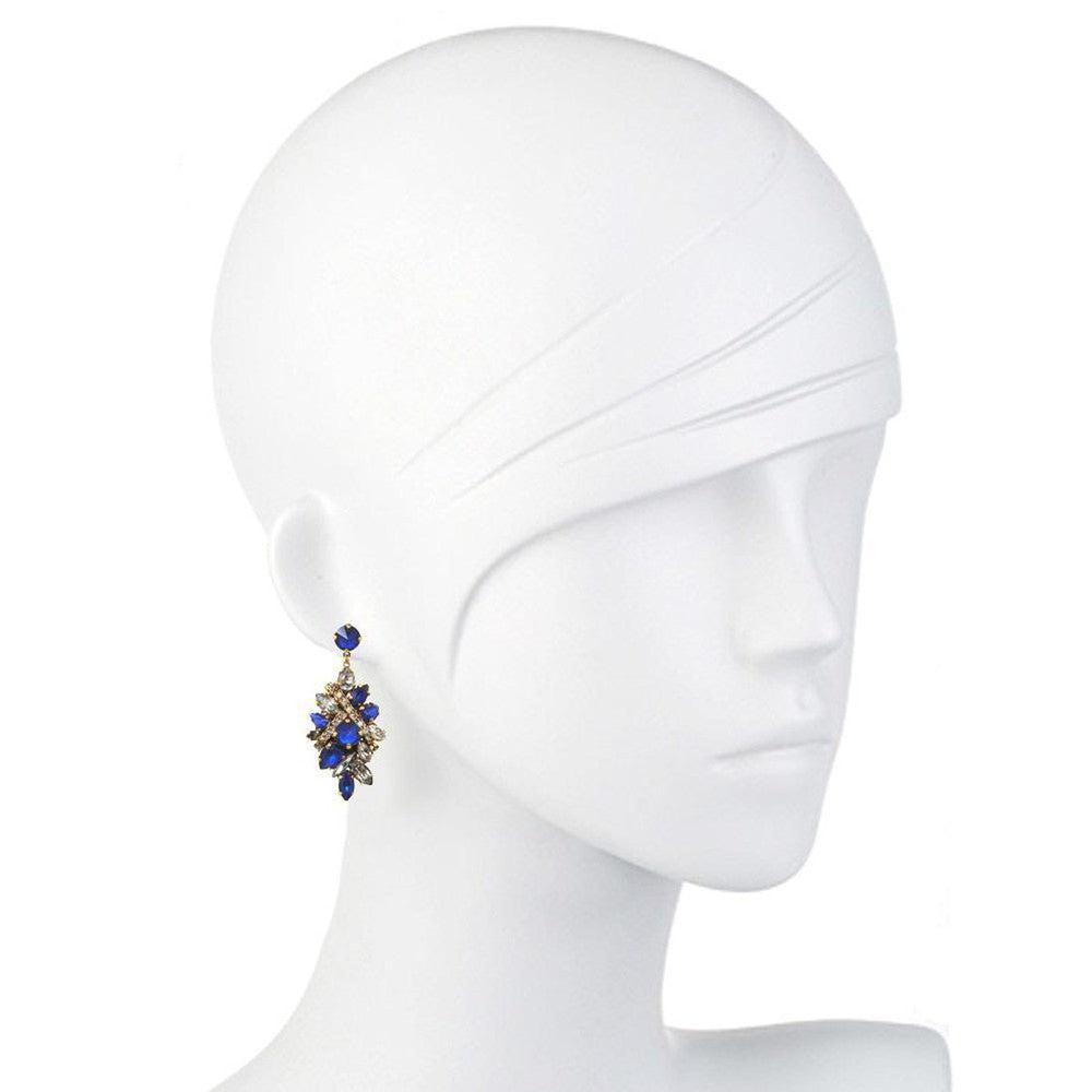 Dazzling blue and clear crystal drop earrings on a mannequin.