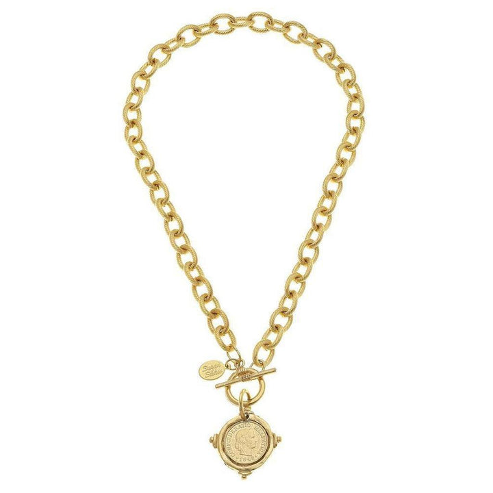 Gold coin pendant necklace with textured chain; features a toggle clasp.