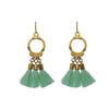 Gold dangle tassel earrings with mint green tassels and gold circular accents.
