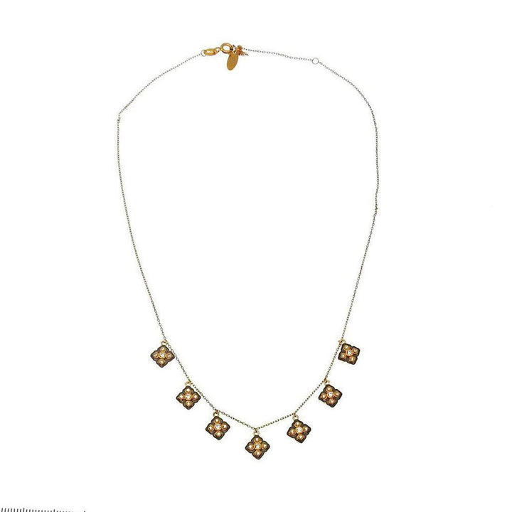 Gold necklace with dangling quatrafoil charms.