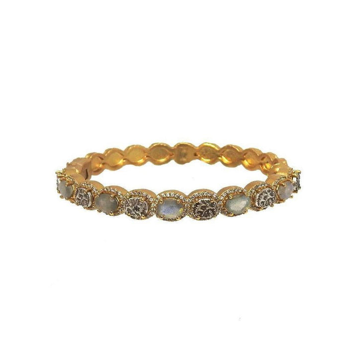 Gold hinged bangle bracelet adorned with moonstone and diamond accents.